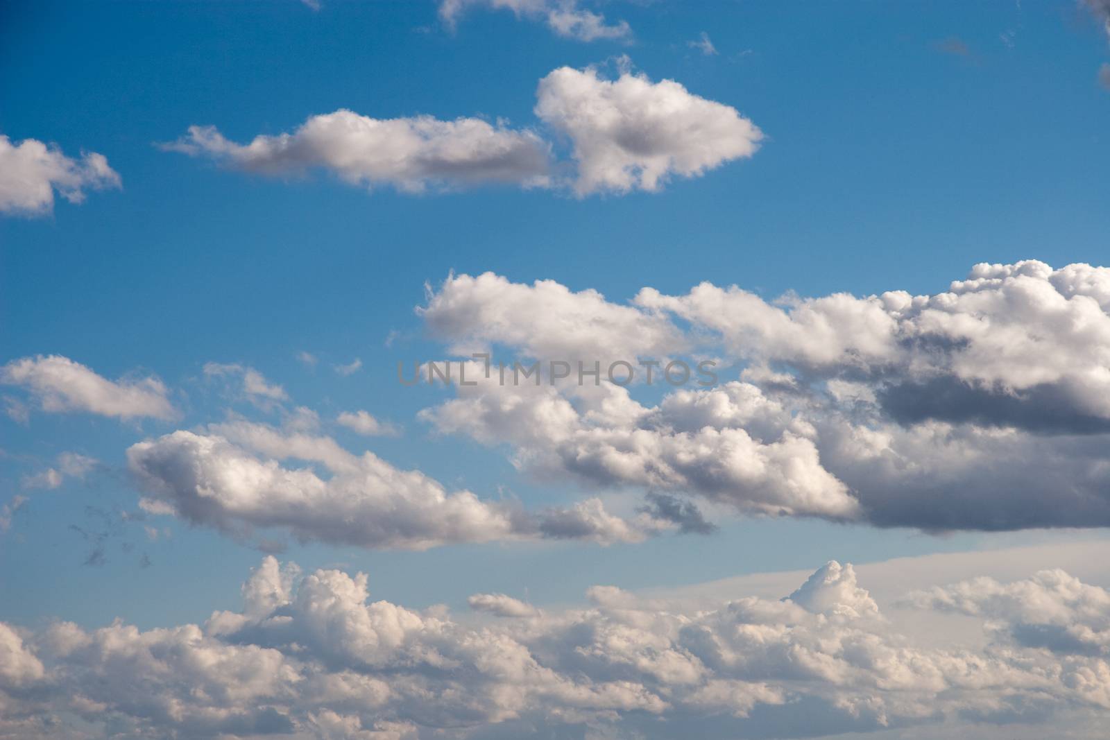Beautiful fluffy clouds in the blue sky background.