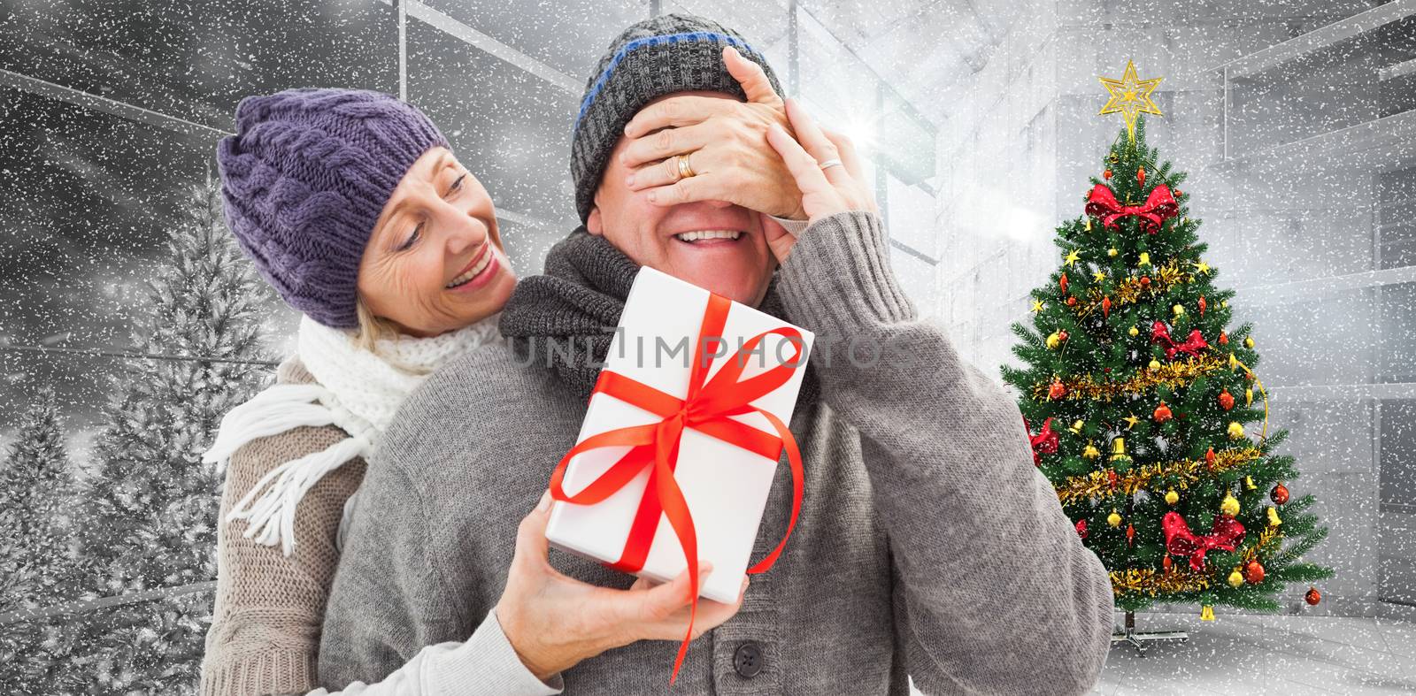 Mature woman surprising partner with gift against home with christmas tree