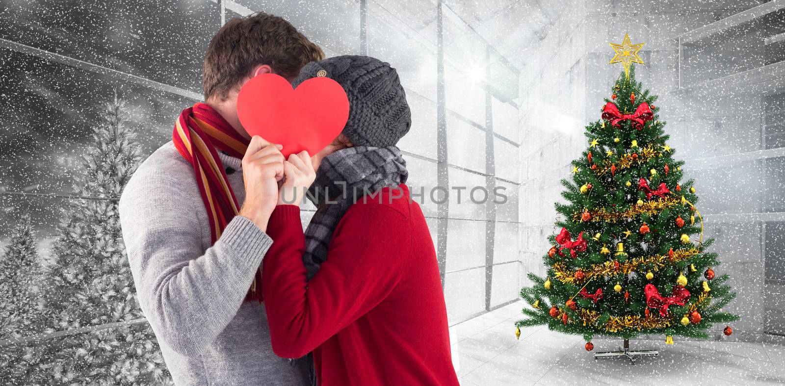 Composite image of couple holding a red heart by Wavebreakmedia