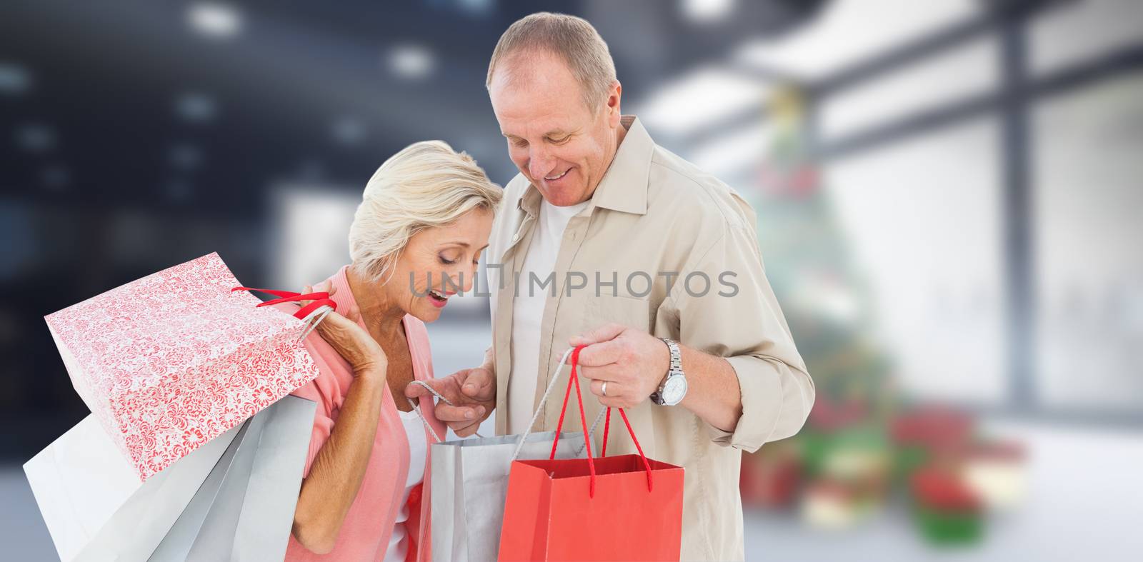 Couple with shopping bags against home with christmas tree