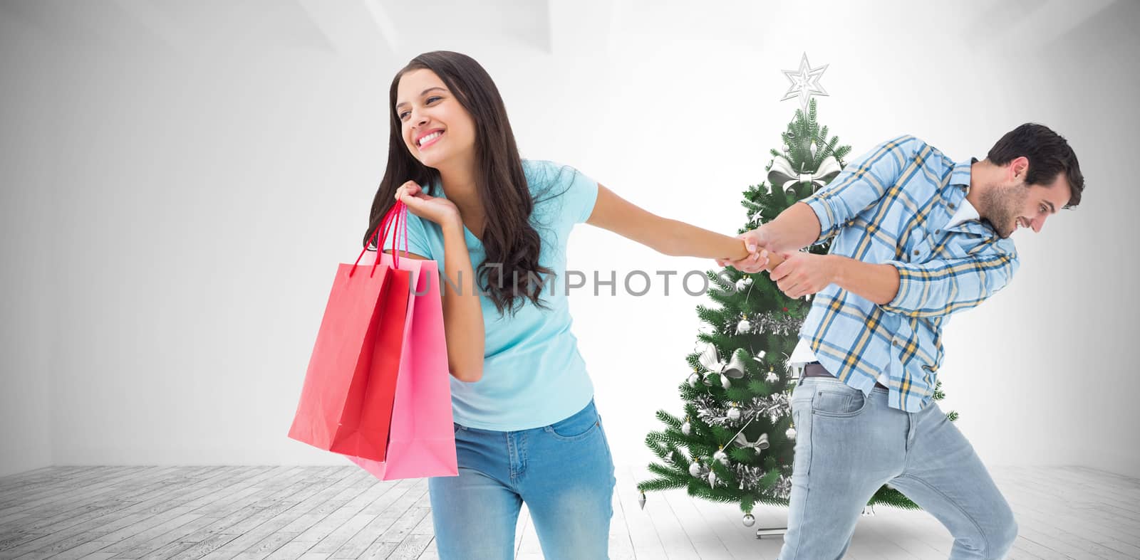 Happy couple with shopping bag against home with christmas tree
