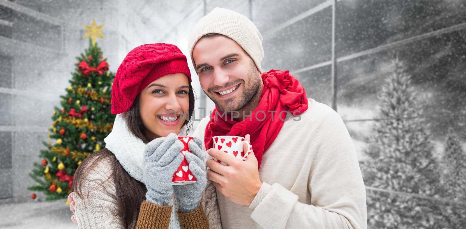 Winter couple holding mugs against home with christmas tree