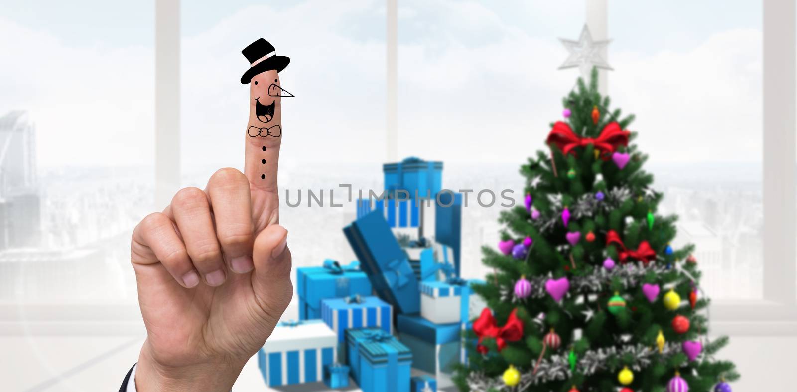 Snowman finger against home with christmas tree
