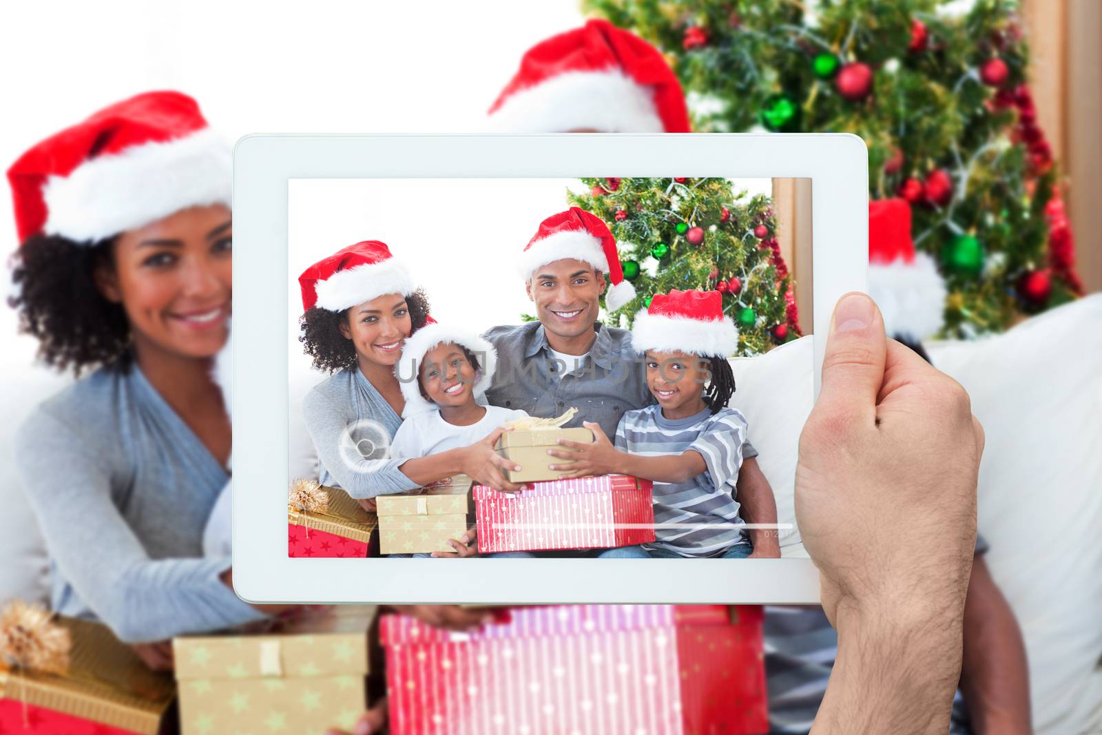 Composite image of hand holding tablet pc