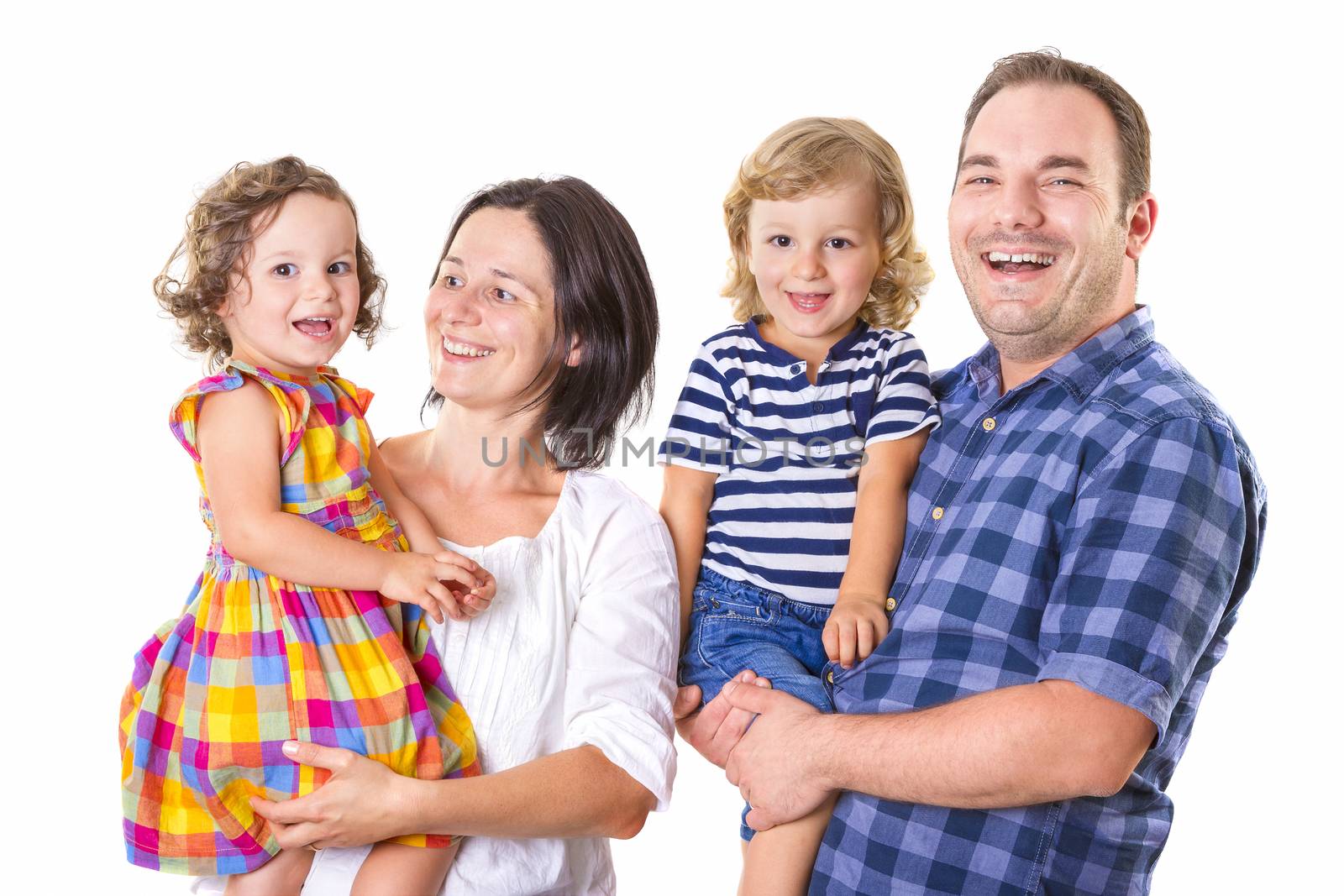 Happy family of four smiling while standing against white background.