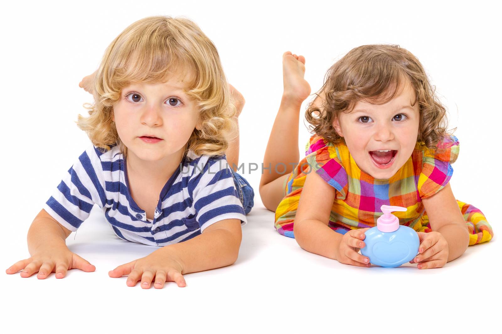 Funny boy and girl are lying together isolated on white background