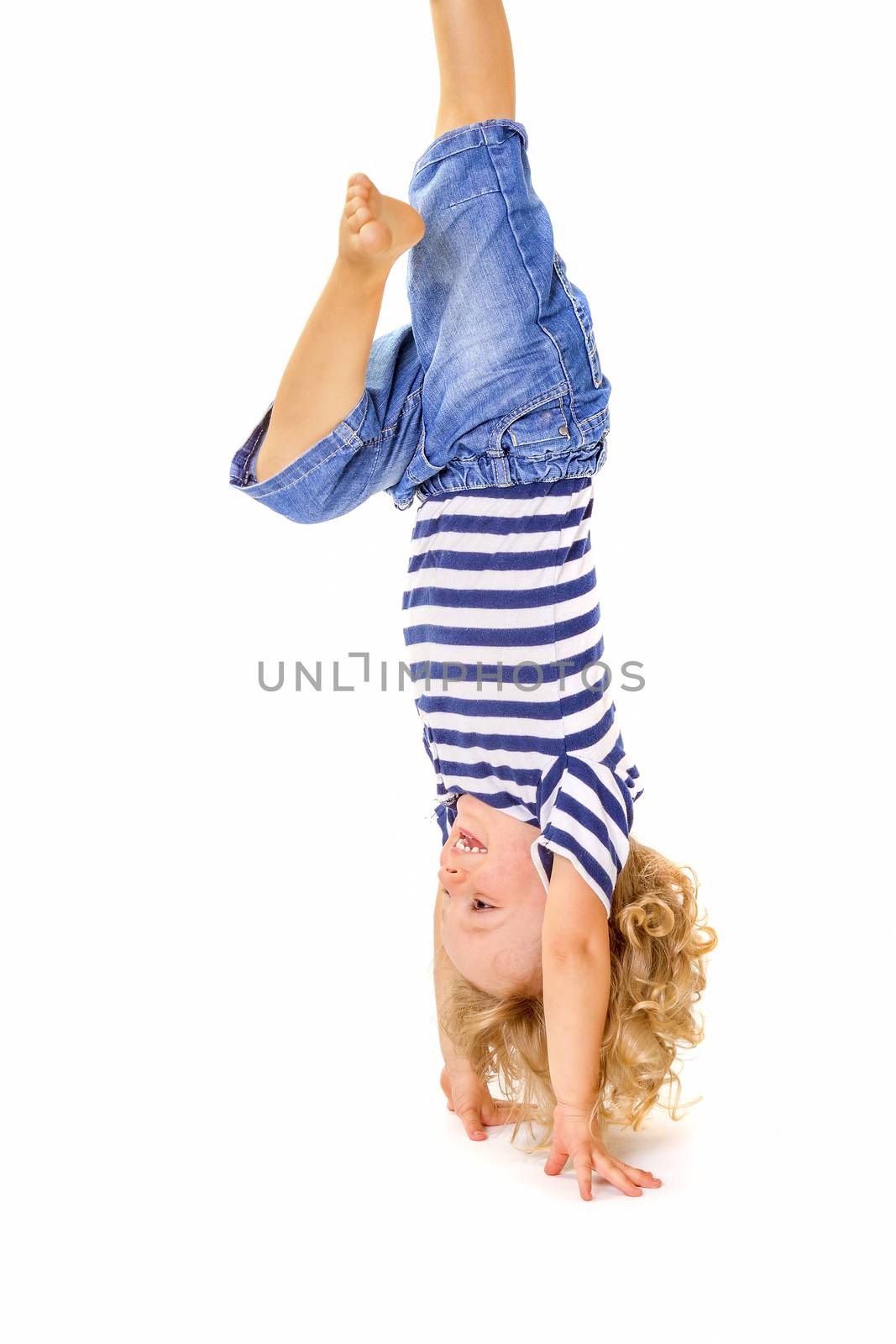 Happy little boy upside down on white background