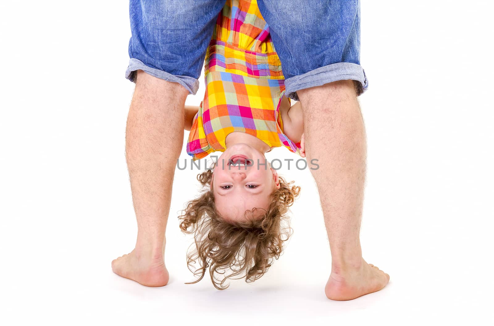 Father holding his little daughter upside down. Trust concept.