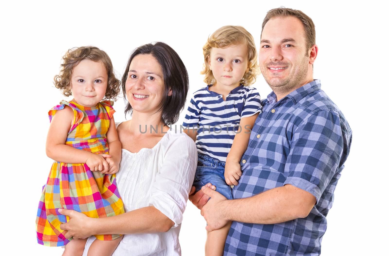 Happy family of four smiling while standing against white background.