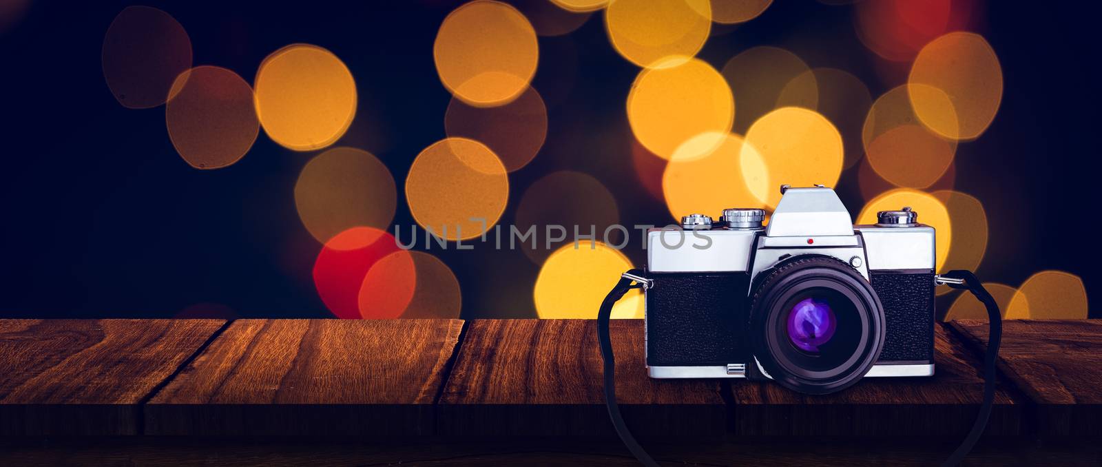 camera against desk with christmas tree in background