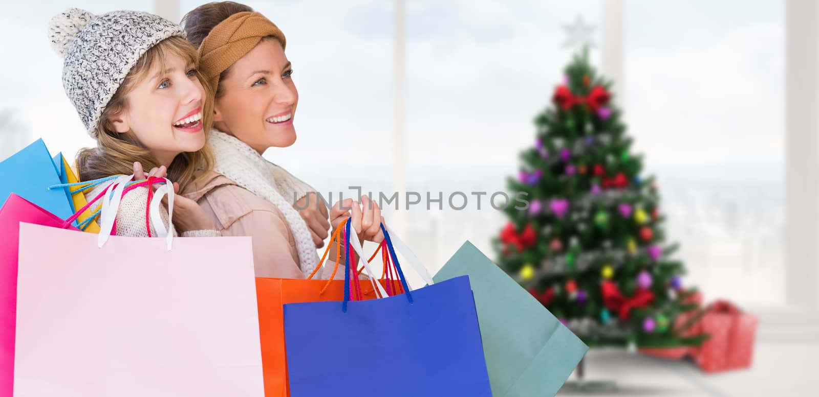 Composite image of beautiful women holding shopping bags looking away  by Wavebreakmedia