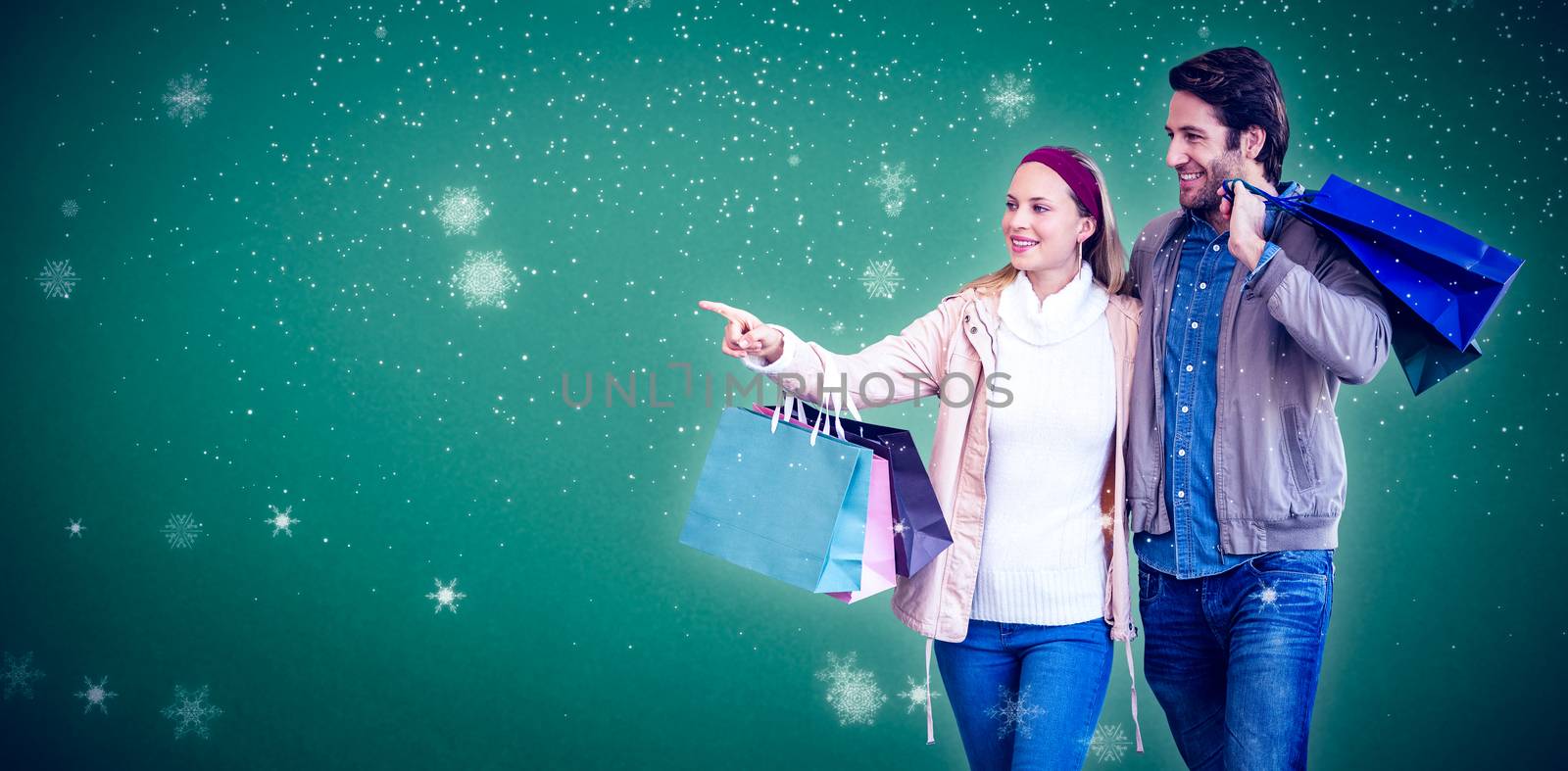Smiling couple walking hand in hand and going window shopping against green