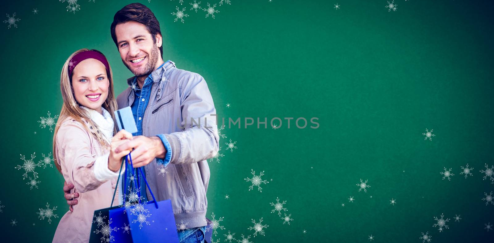 Composite image of smiling couple showing credit card and shopping bags by Wavebreakmedia