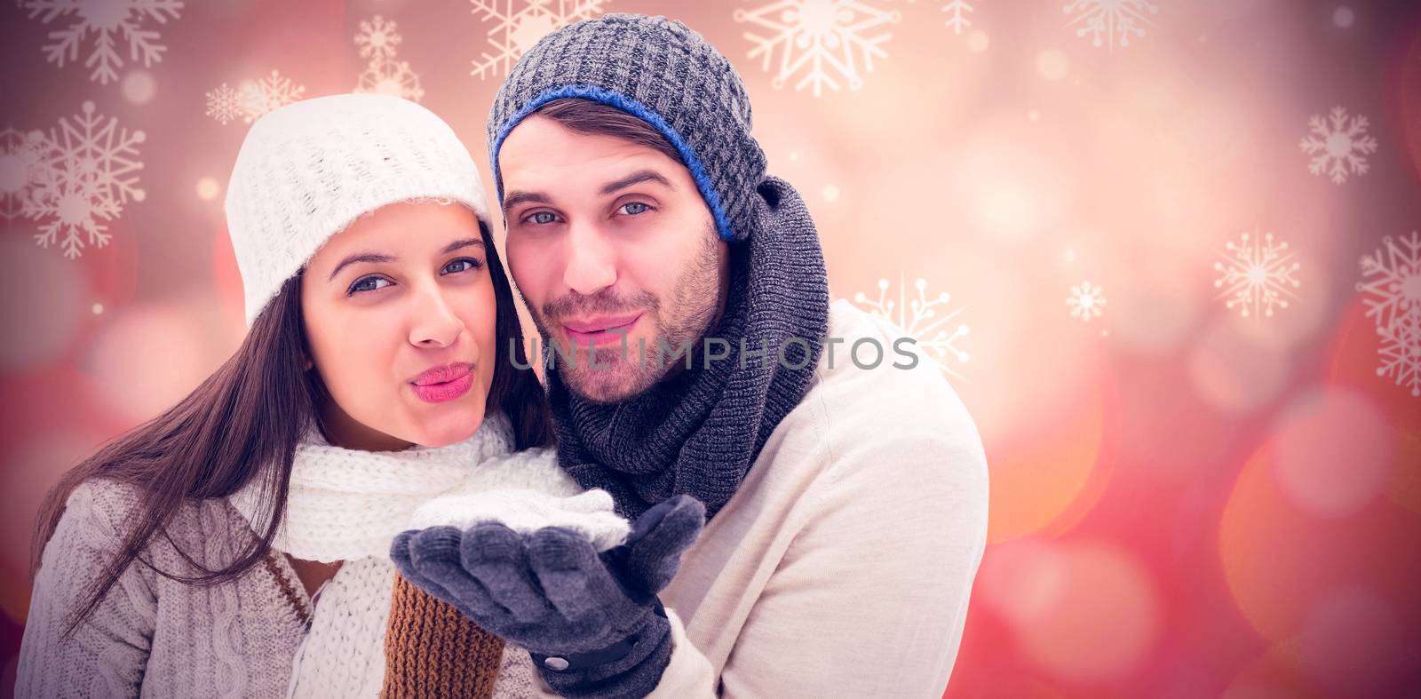 Young winter couple against glowing christmas background
