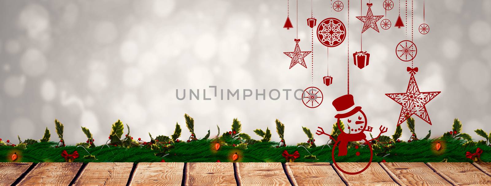 Hanging red christmas decorations against grey abstract light spot design