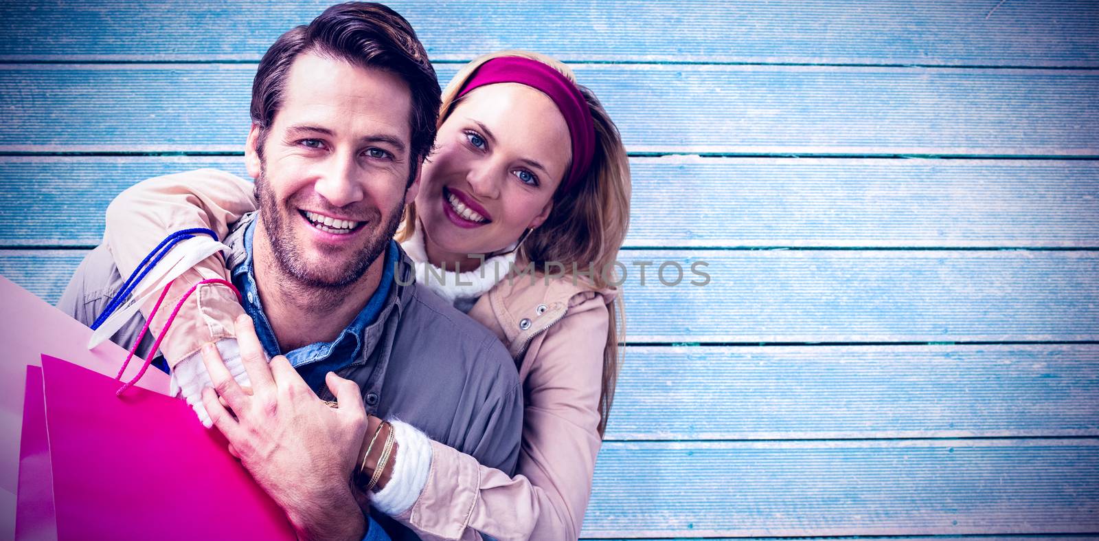 Composite image of smiling couple embracing  by Wavebreakmedia