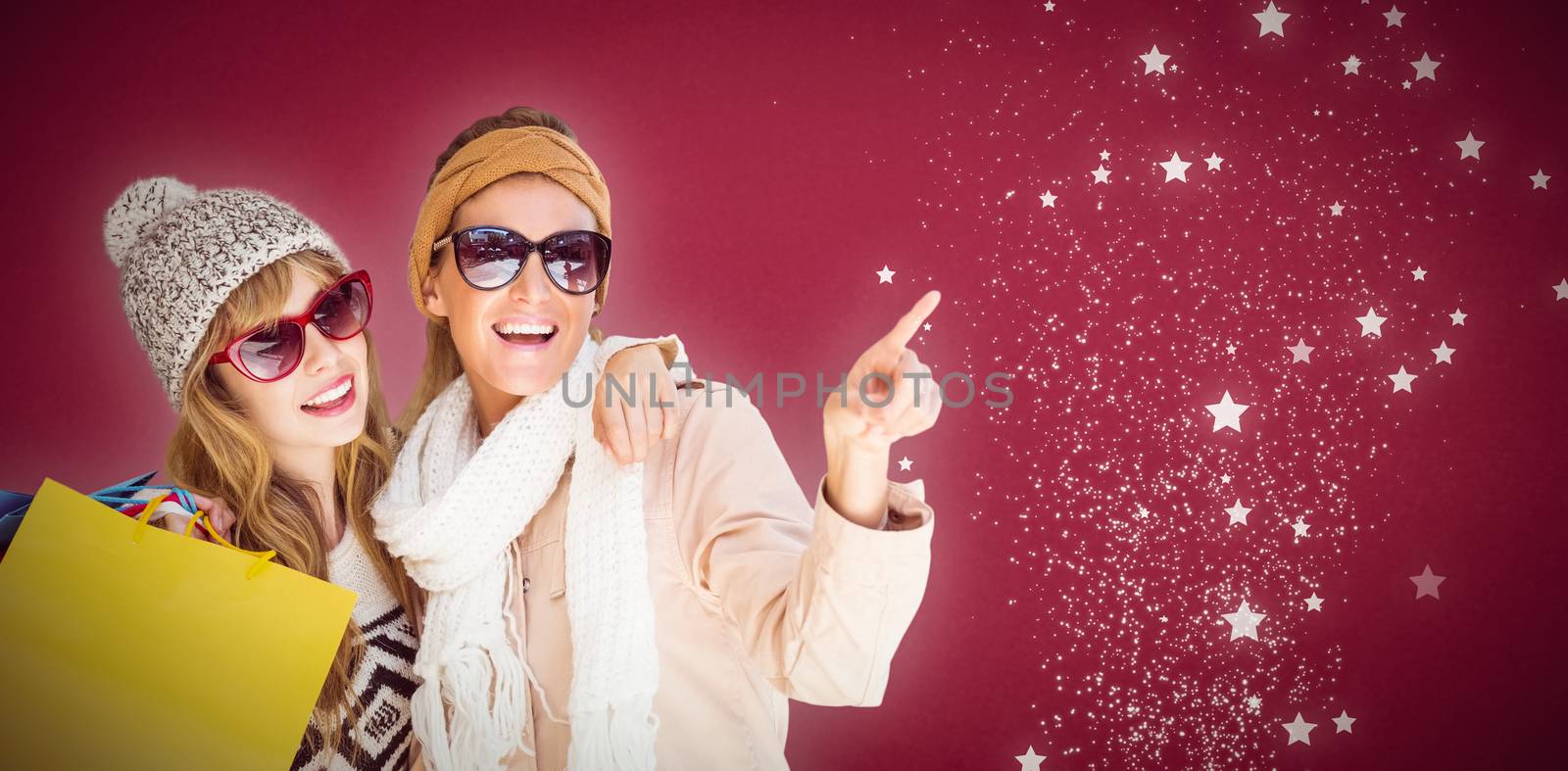 Beautiful women holding shopping bags pointing  against red background