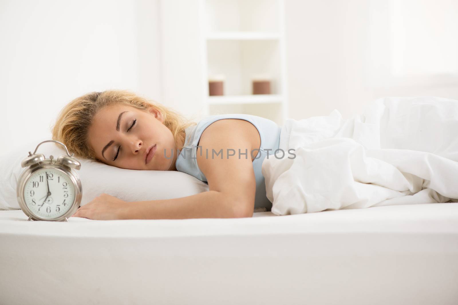 Beautiful young woman sleeping in bed.