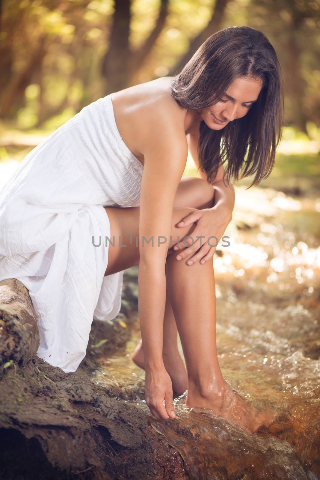Young beautiful woman relaxing the stream in the nature. 