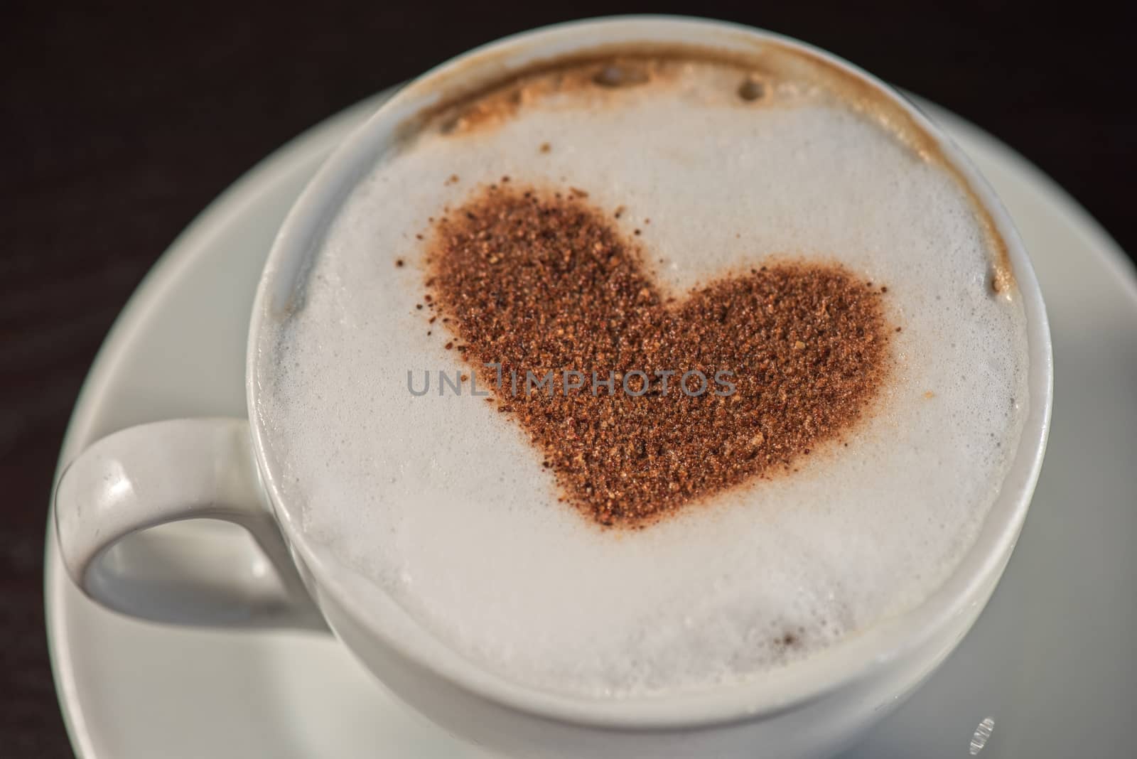 Coffee cup with milk and heart shape