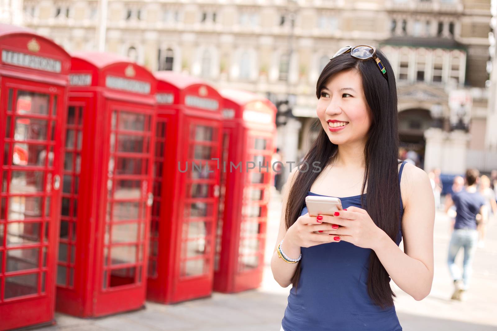 young woman in London with her phone