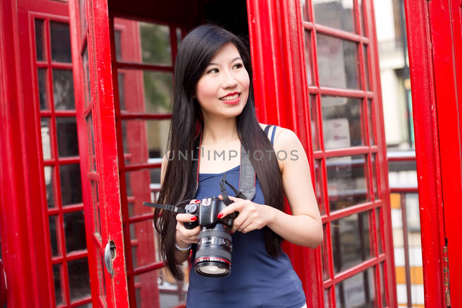 japanese tourist in london holding her camera