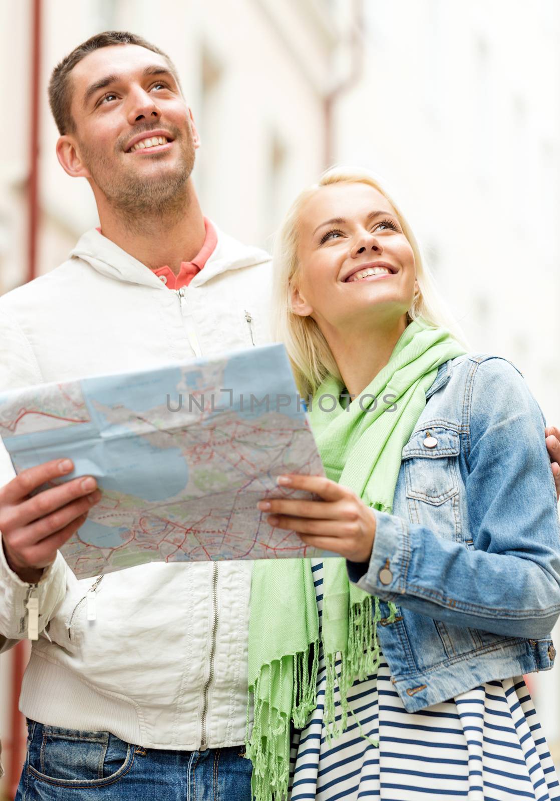 happy couple with map exploring city by dolgachov