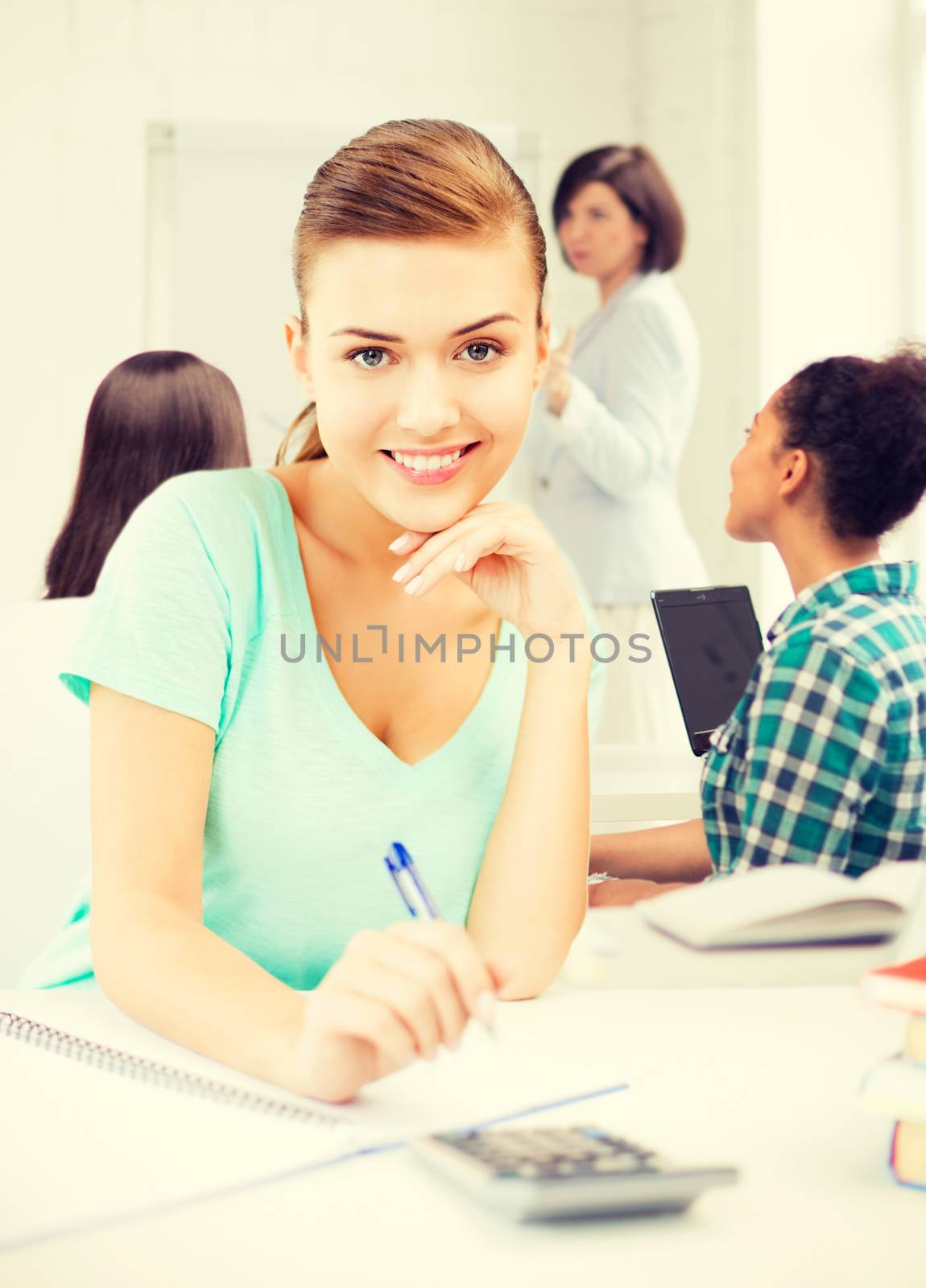 picture of student girl with notebook and calculator at school