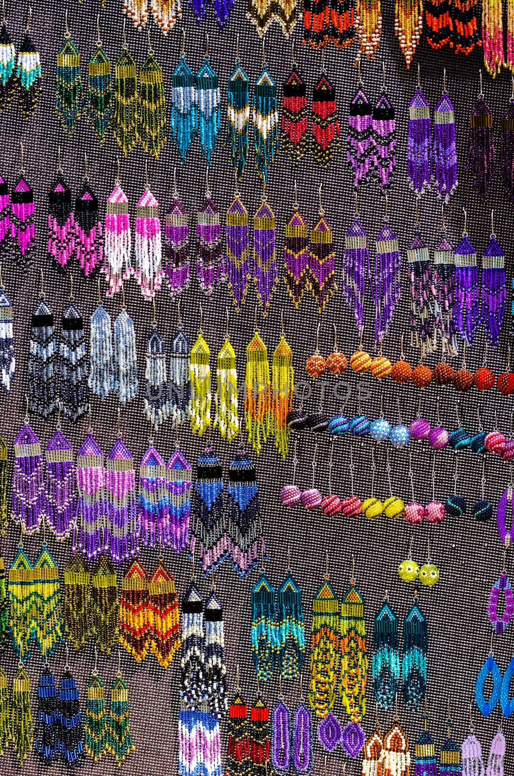 Colourful handmade earrings on a market stall