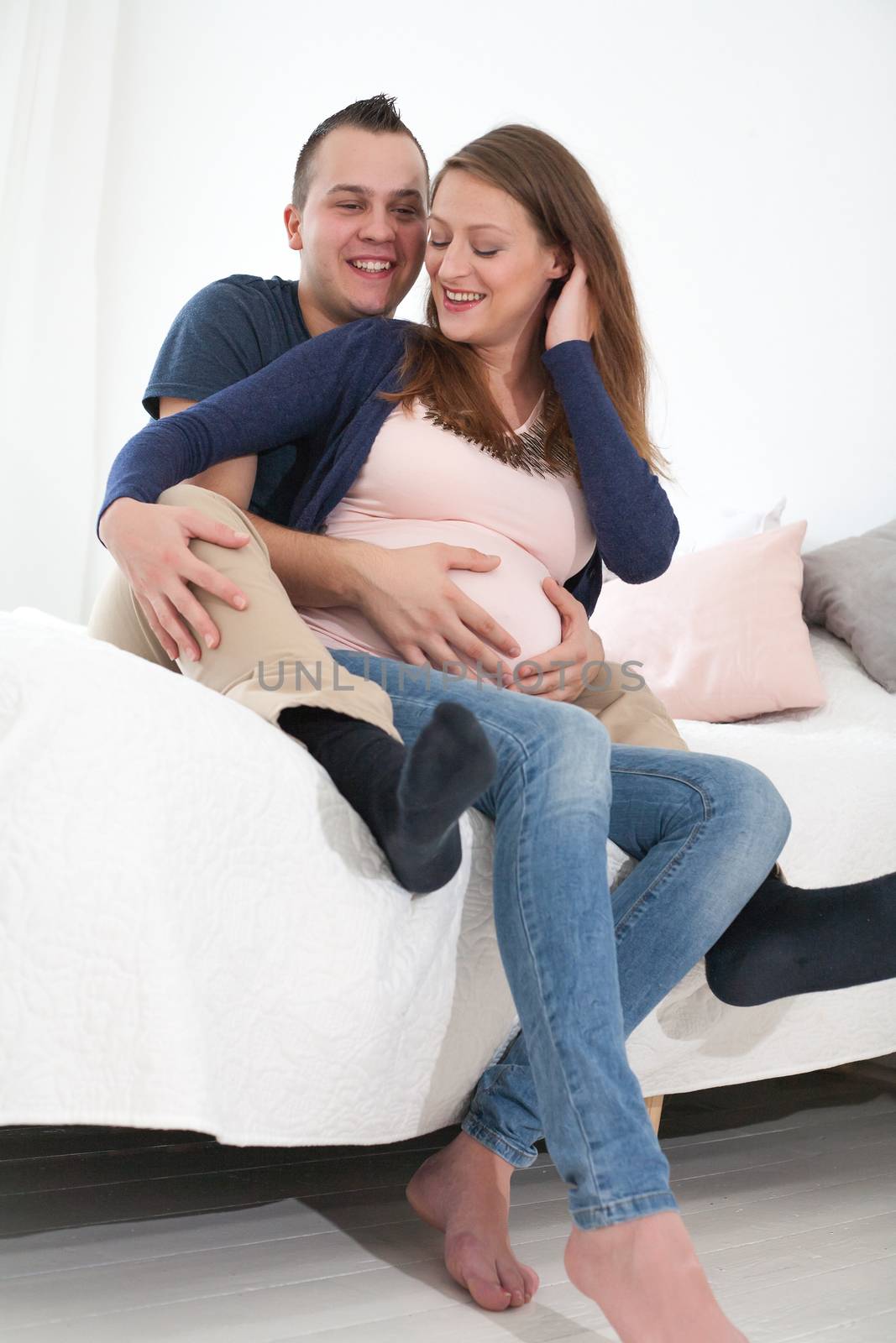 happy young pregnant couple by DNFStyle