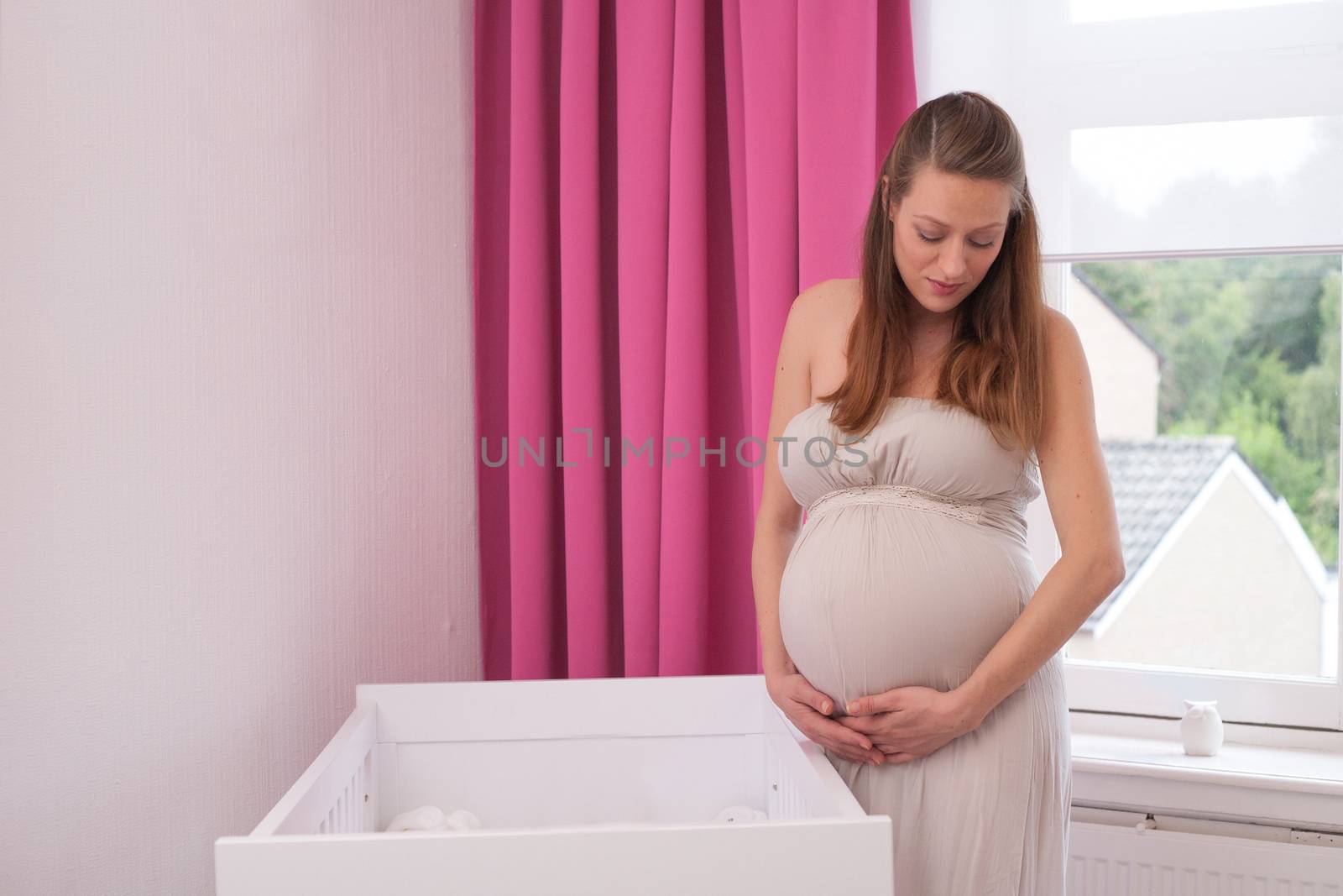 Young new mother in the new babyroom