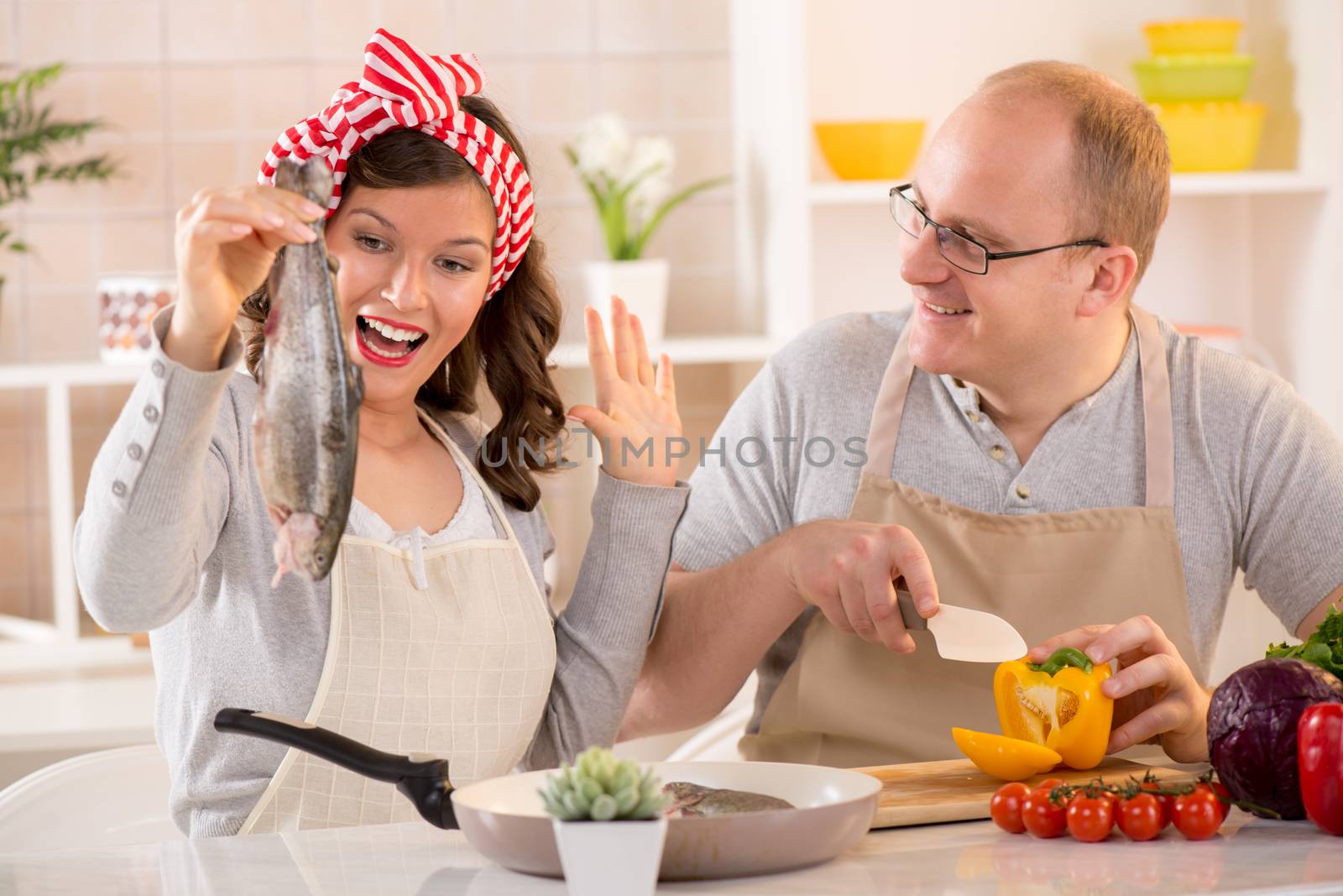 Happy couple preparing food in the kitchen