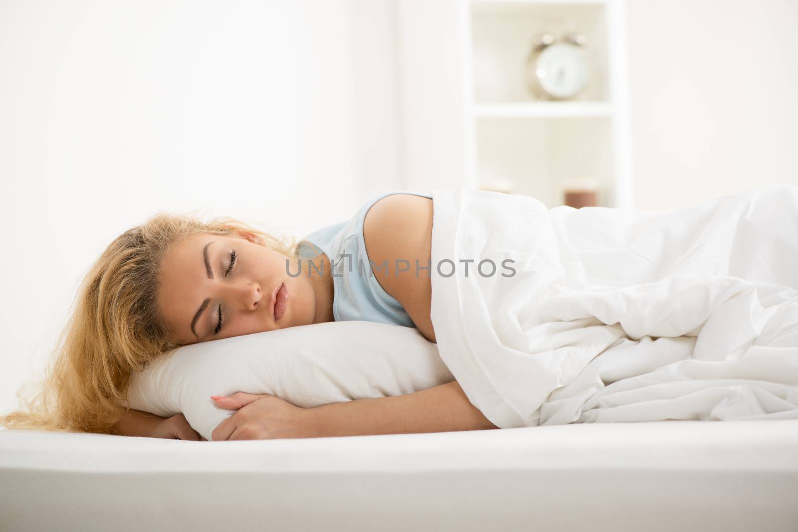 Beautiful young woman sleeping in bed.