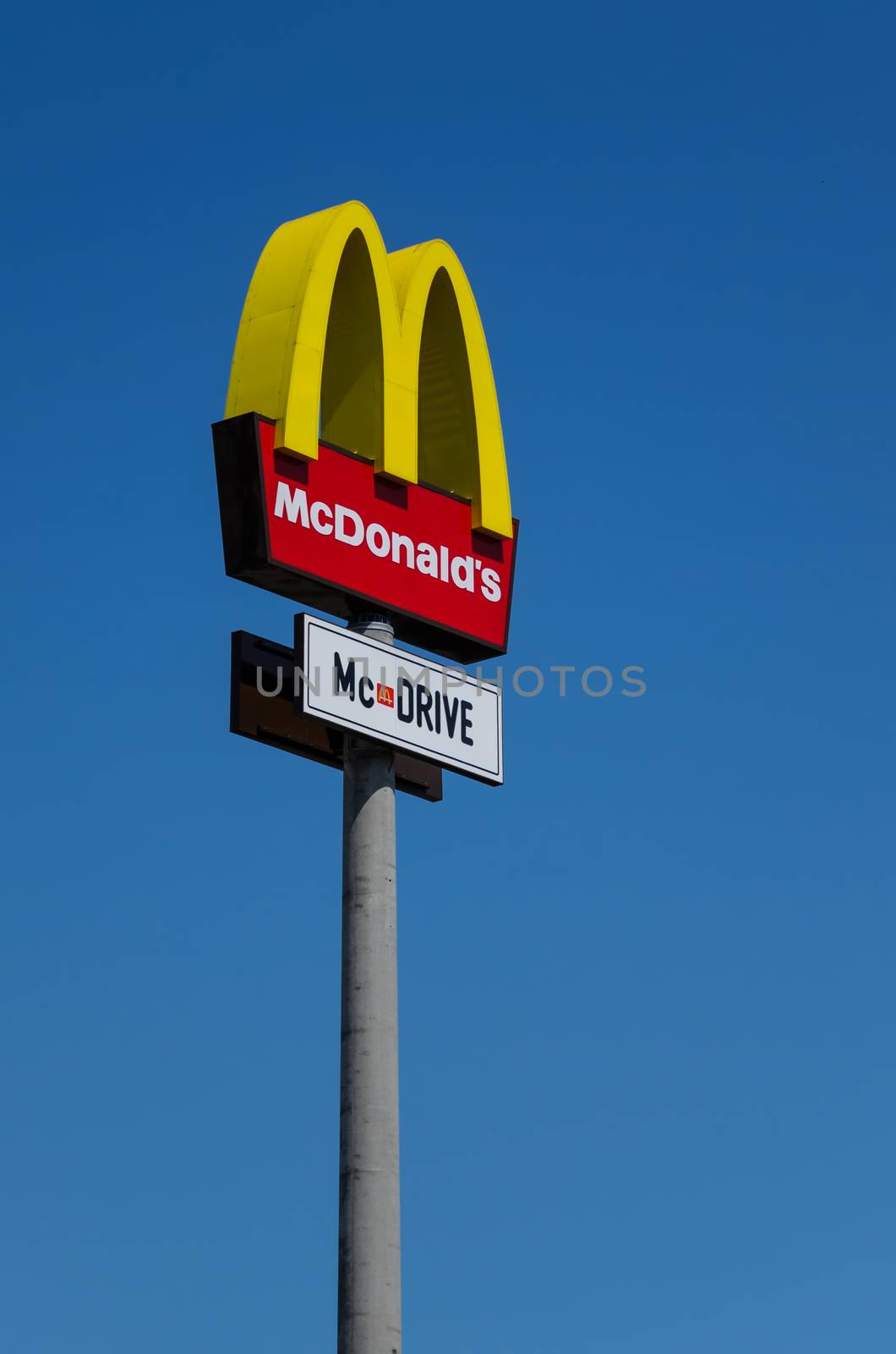 McDonalds logo on blue sky background by Attila