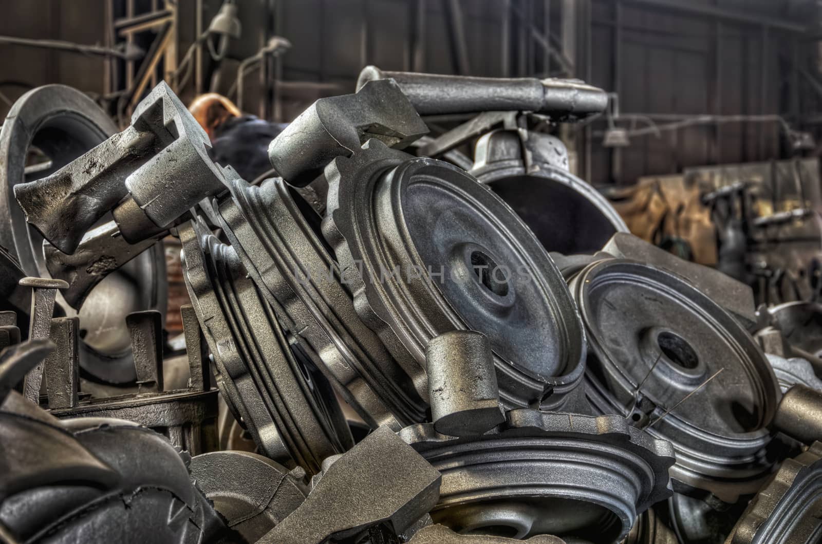 Stack of cast metal parts in a iron foundry by Attila