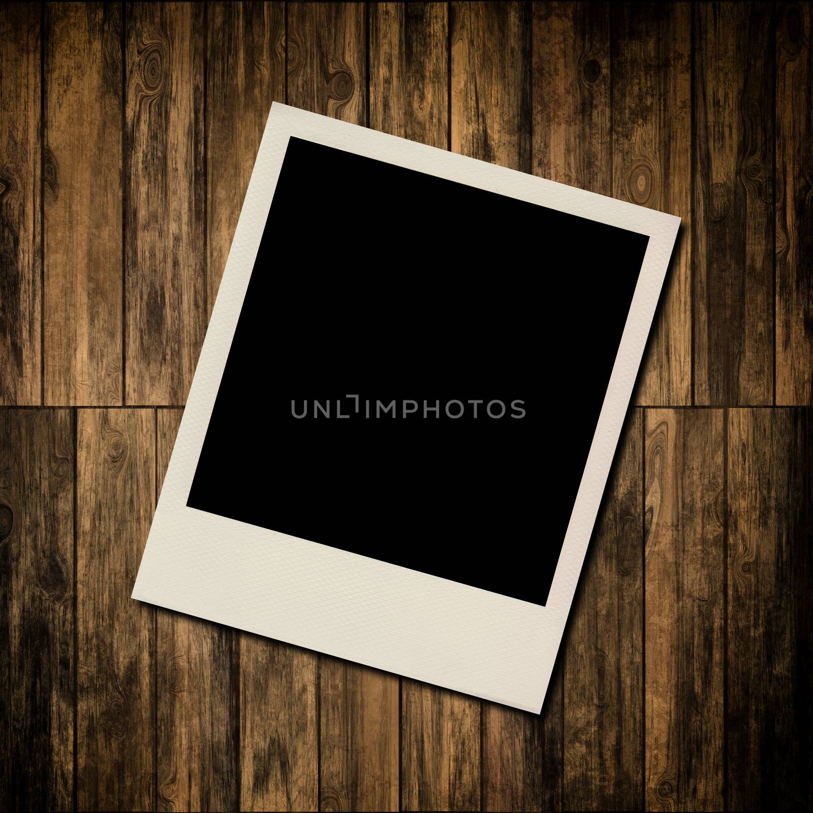 Blank instant photo frame on old wooden background