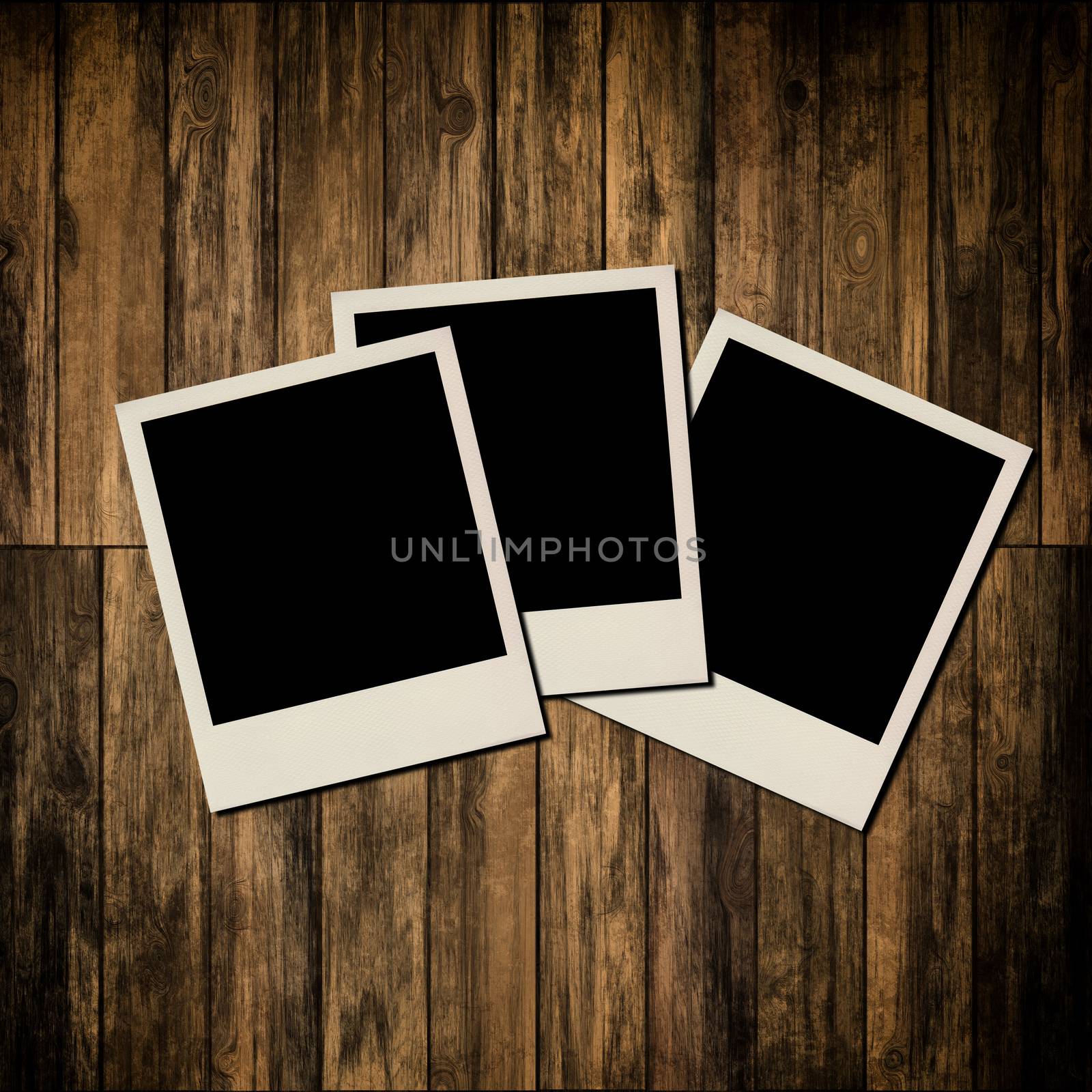 Blank instant photo frames on old wooden background by Attila
