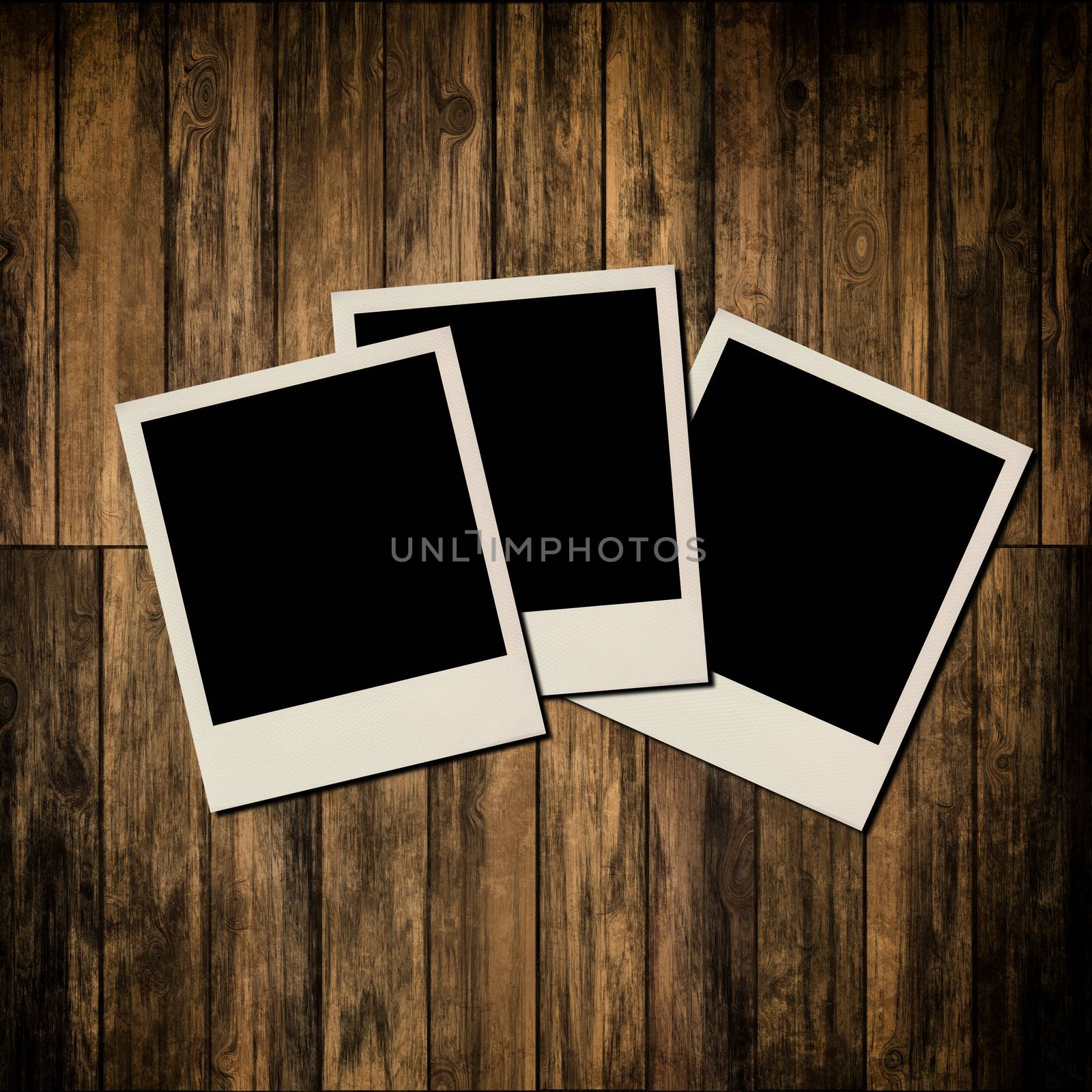 Blank instant photo frames on old wooden background