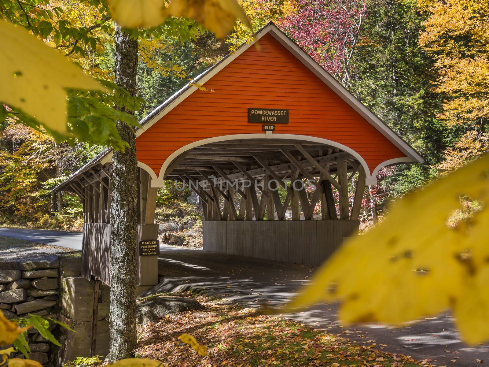 Red covered bridge in Fanconia New Hampshire during Fall season