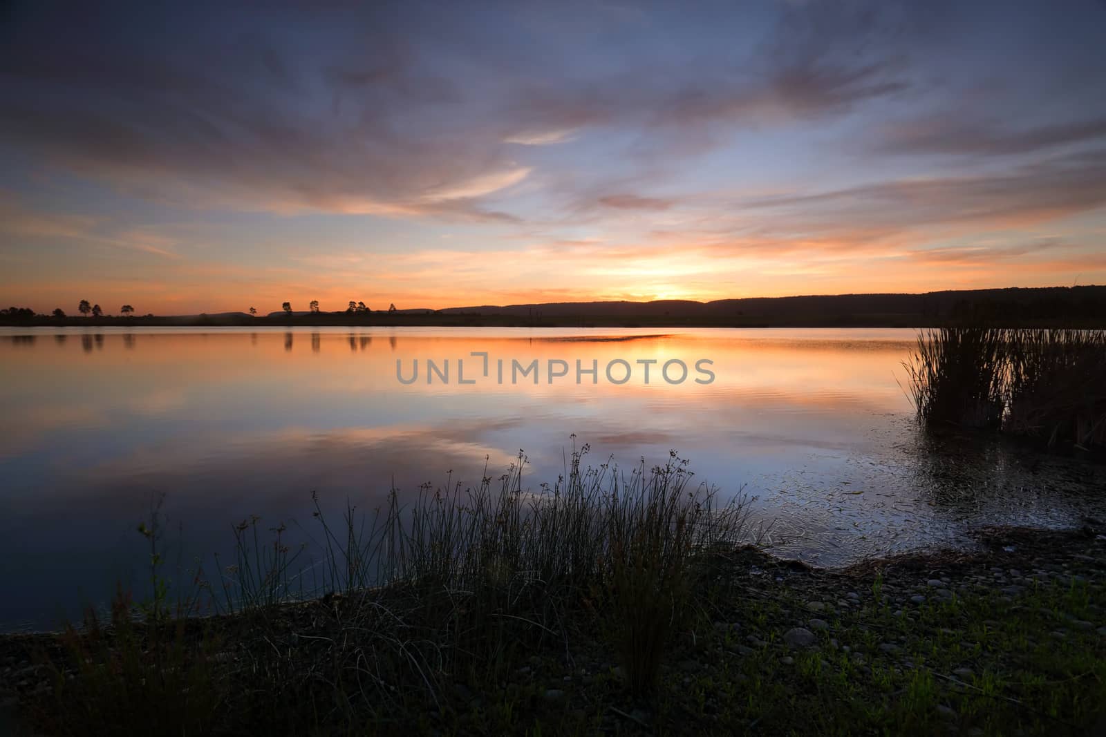 Soft peachy oranges, aqua blues and soft lemons decorate the sky as the sun sinks behind the Blue Mountains and ever still waters perfectly reflect the sky above.  Duralia Lake Penrith