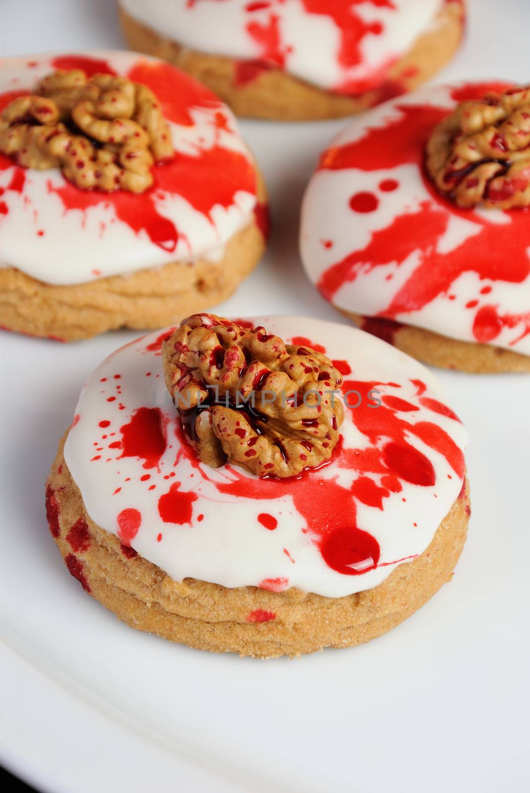 Cookies in white glaze drip blood and walnuts