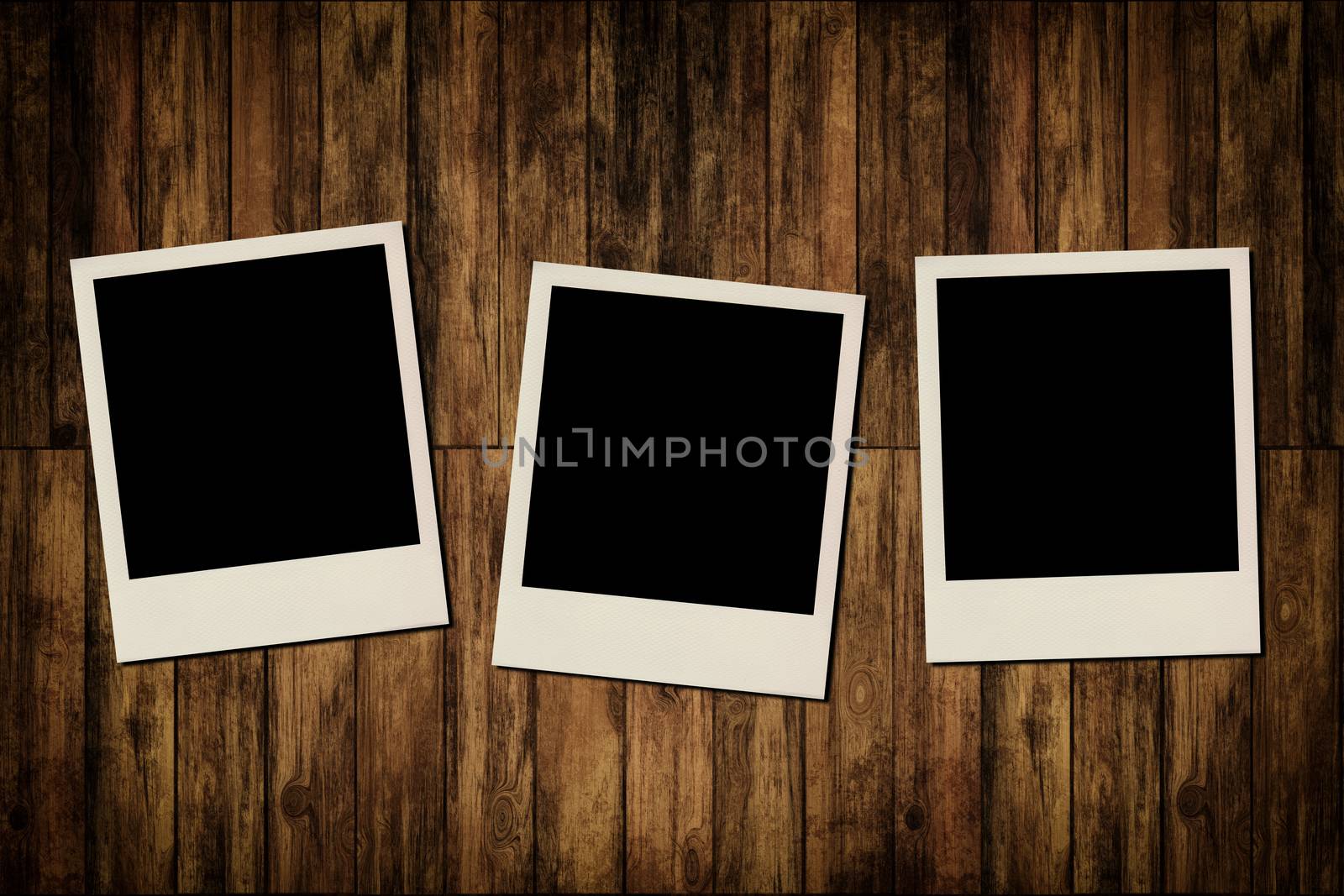 Blank instant photo frames on old wooden background