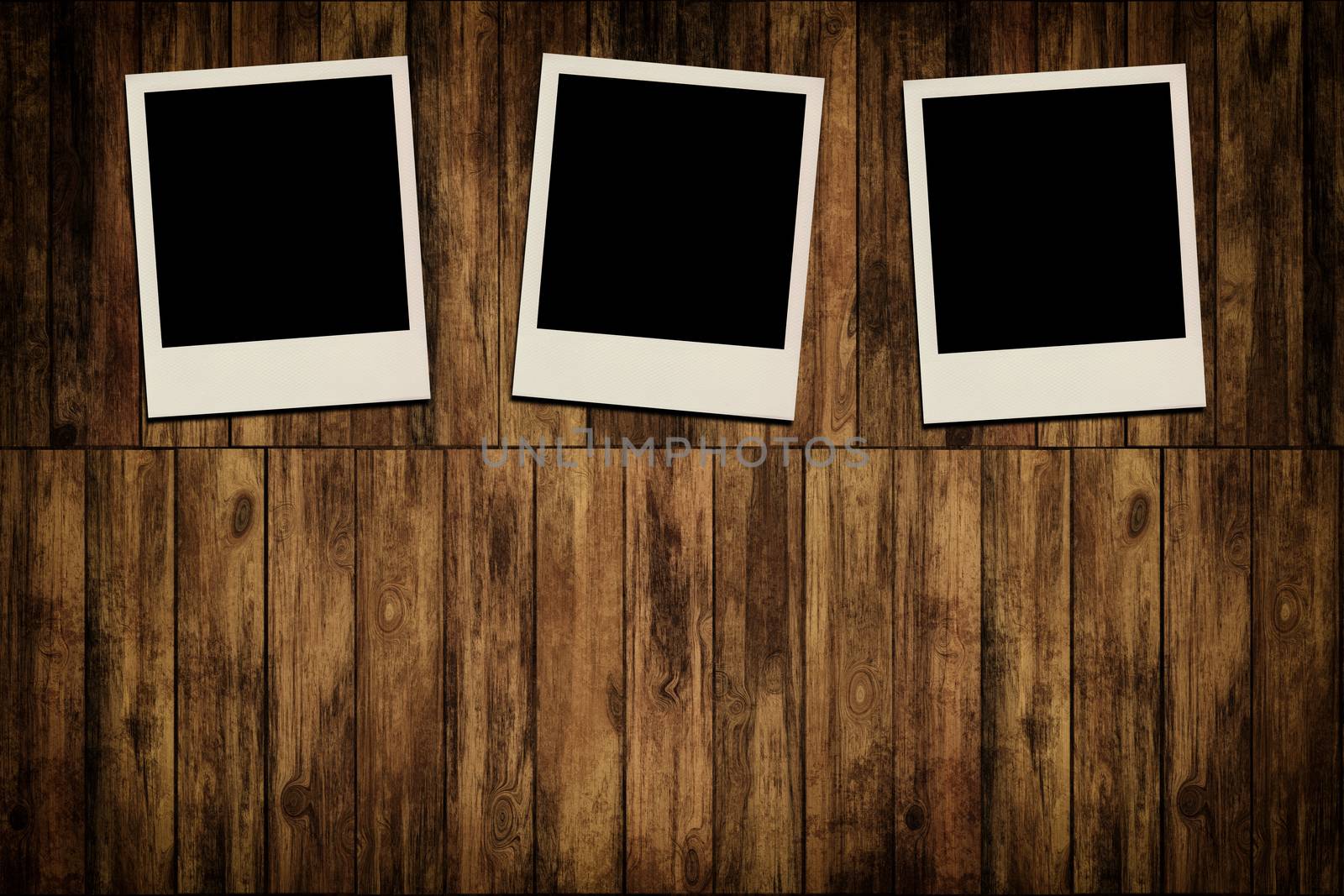 Blank instant photo frames on old wooden background
