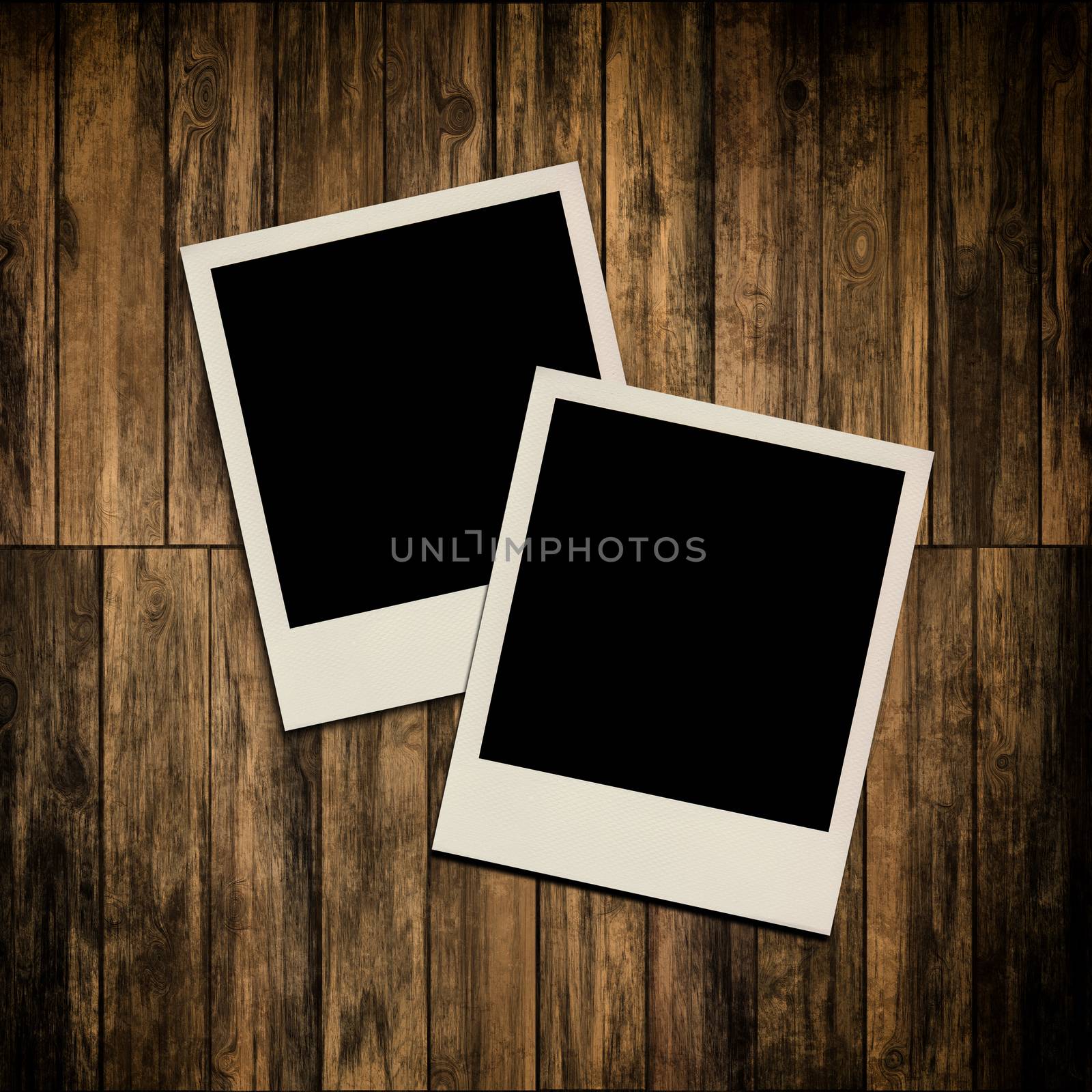 Blank instant photo frames on old wooden background by Attila