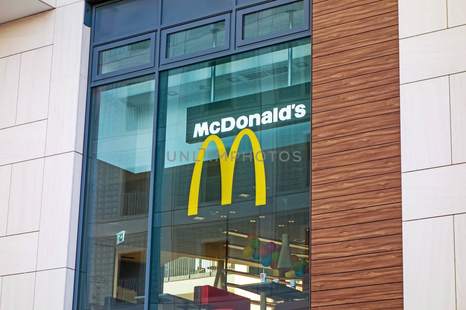 Stuttgart, Germany - November 1, 2013: McDonald's fast food restaurant - window with logo and brand of the fast food chain. The McDonald's Corporation is the world's largest chain selling hamburgers and fast food.