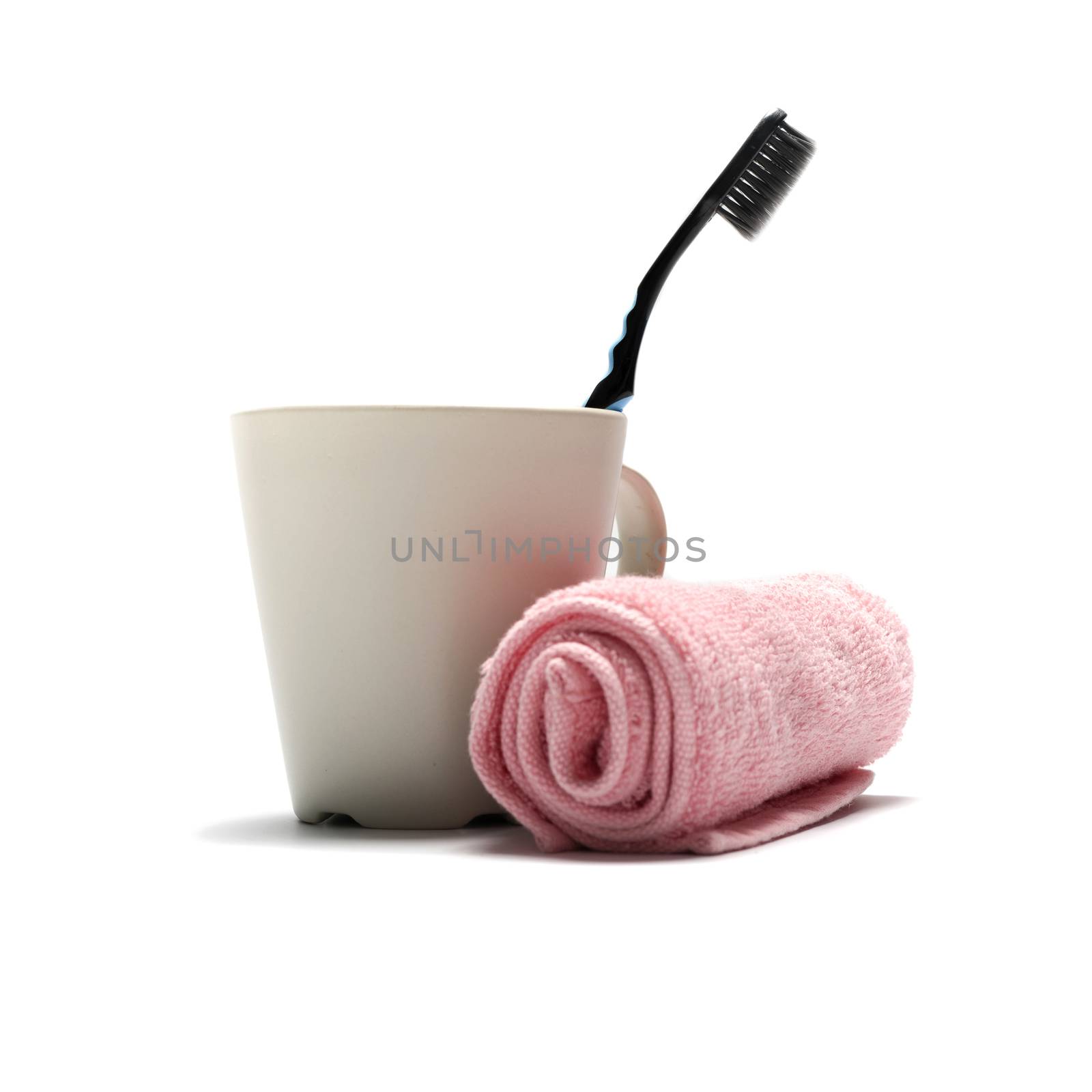 tooth brush and towel with mug isolated on white background