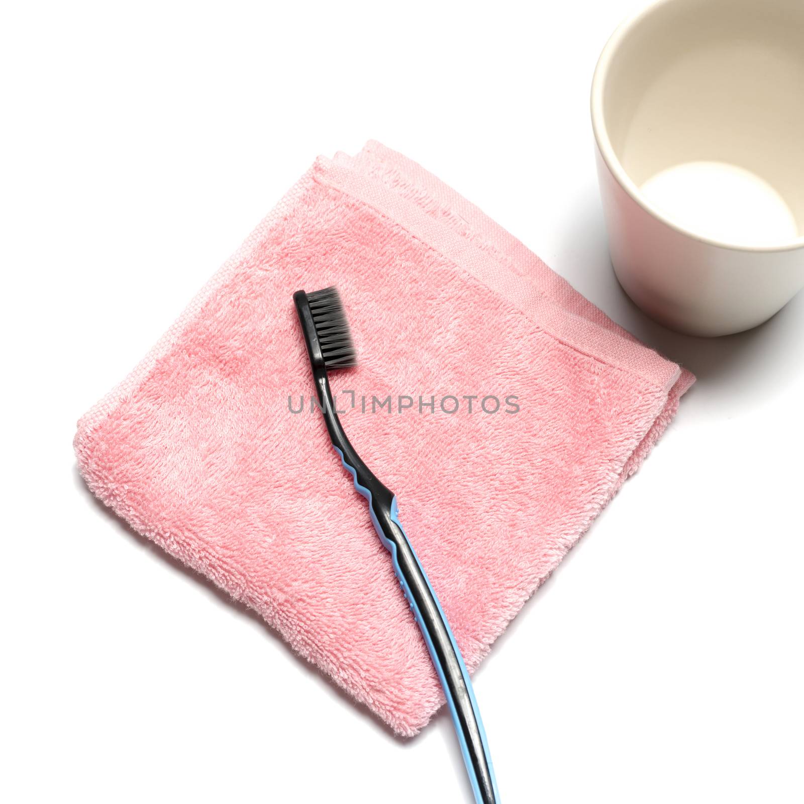 tooth brush and towel with mug isolated on white background