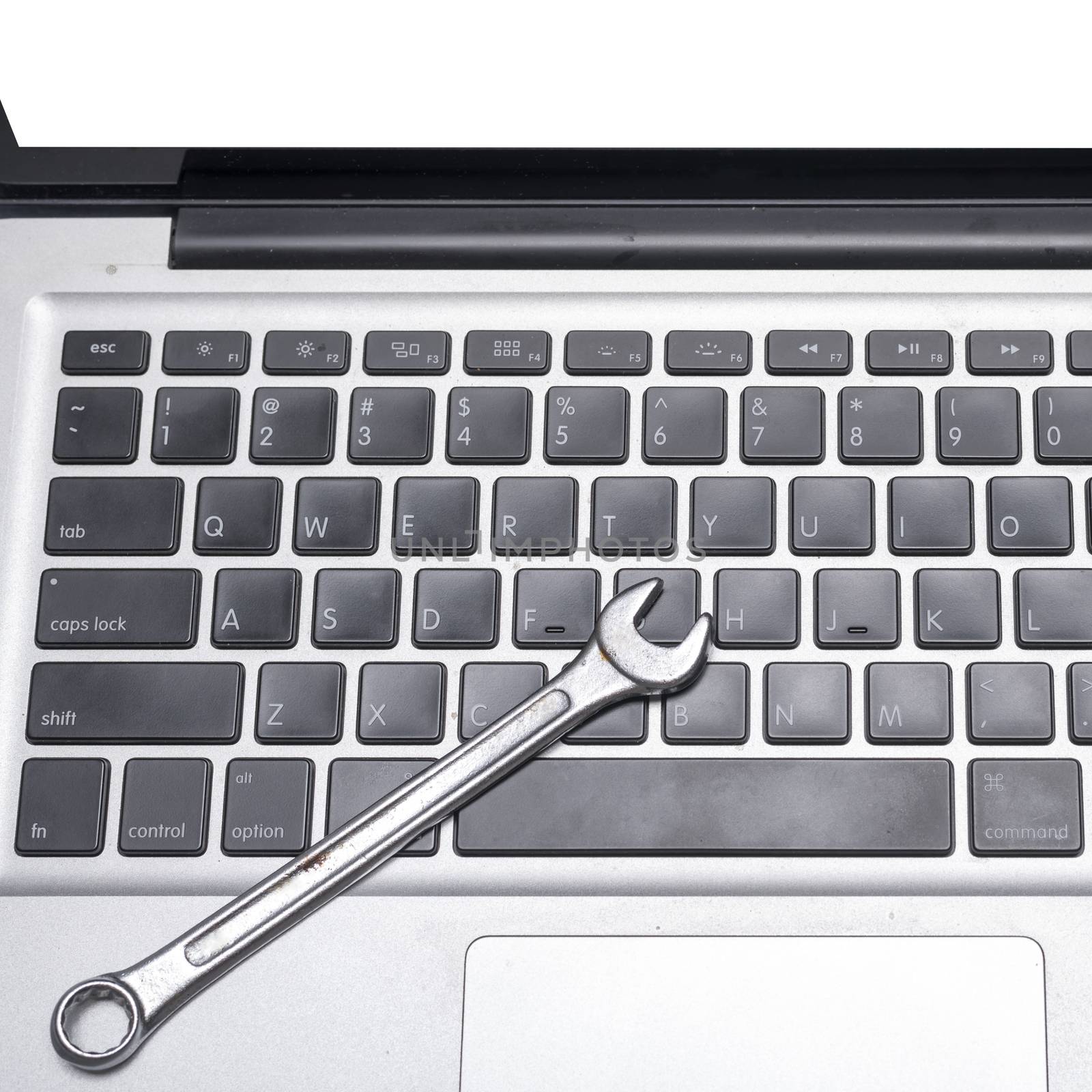 wrench on laptop concept fixing it