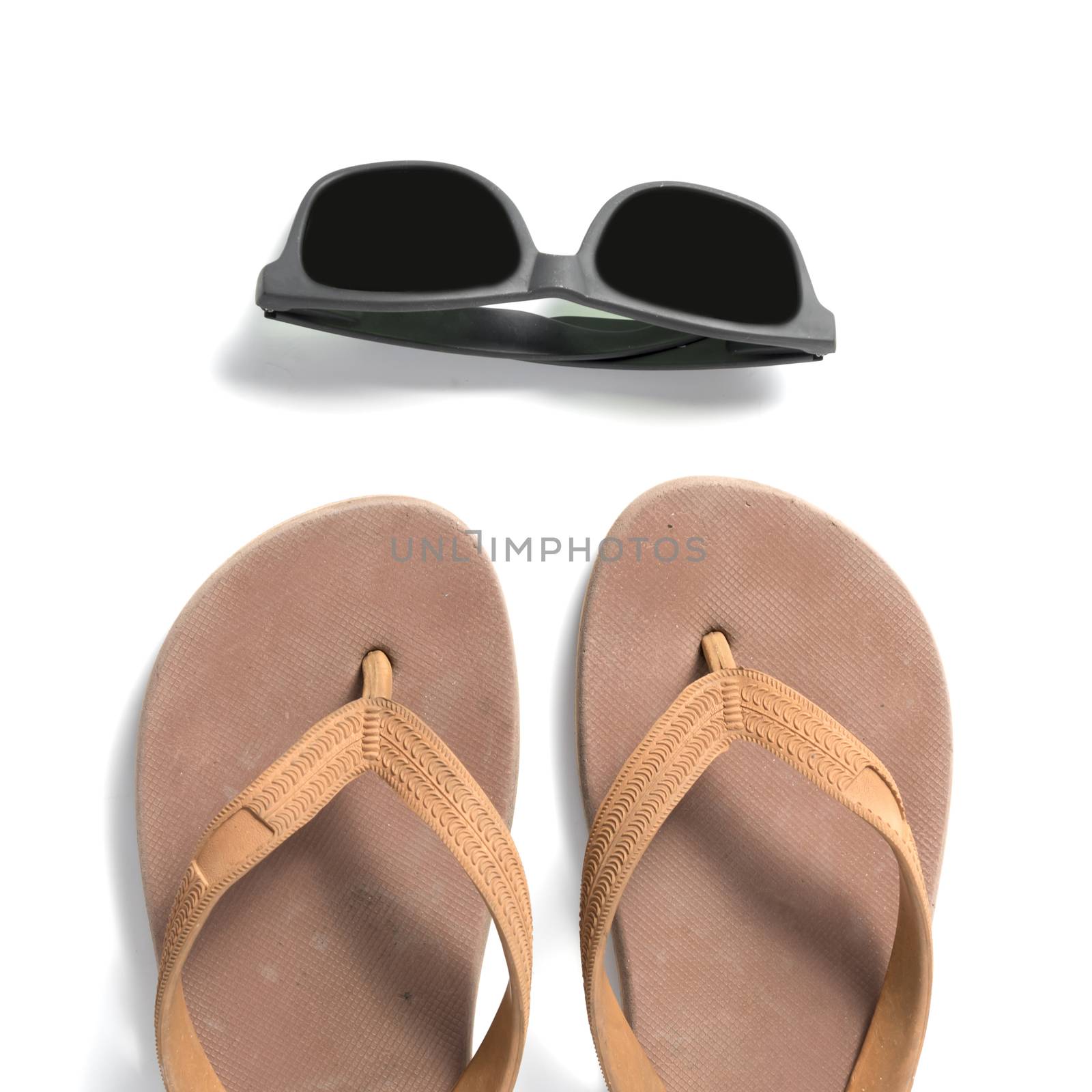 sunglasses and slippers isolated on white background