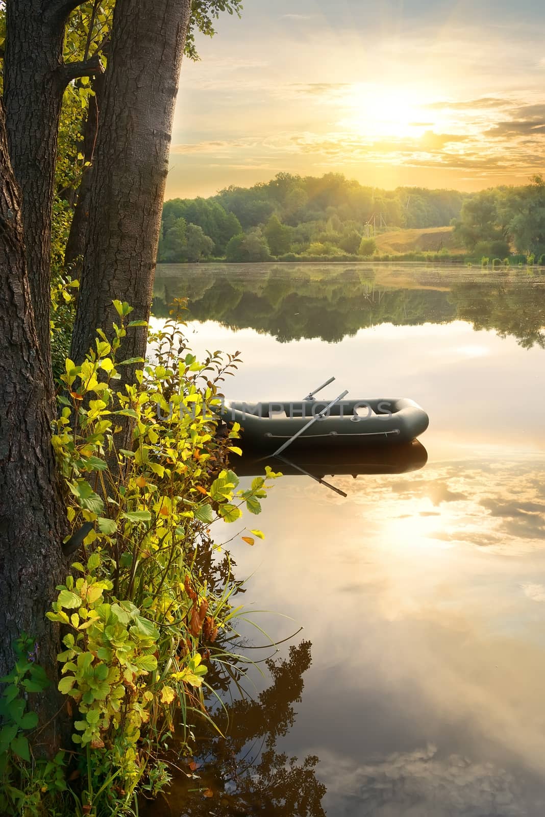 Inflatable boat on river at the sunrise